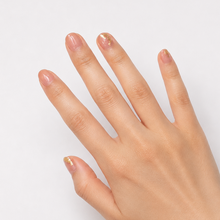 Load image into Gallery viewer, Hand with painted nails with gold foil art on a light gray background