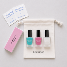 Load image into Gallery viewer, Nail care set with nail polish bottles, a pink tool, and an alcohol pad on a white background.