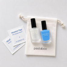 Load image into Gallery viewer, Two nail polish bottles with a pouch labeled 'peelaboo' on a light gray background.