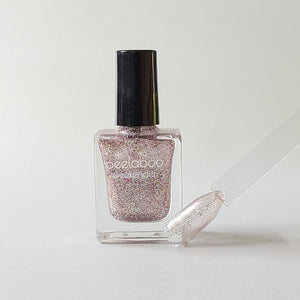 peelable water-based 'Glam' polish bottle with colored sample nail